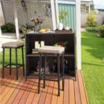 A table and stools on a deck.