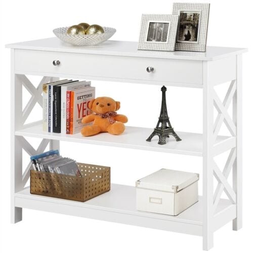 A white shelf with pictures and objects on it.