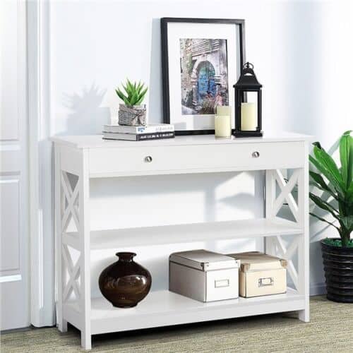 A white shelf with a picture and a picture frame on top.
