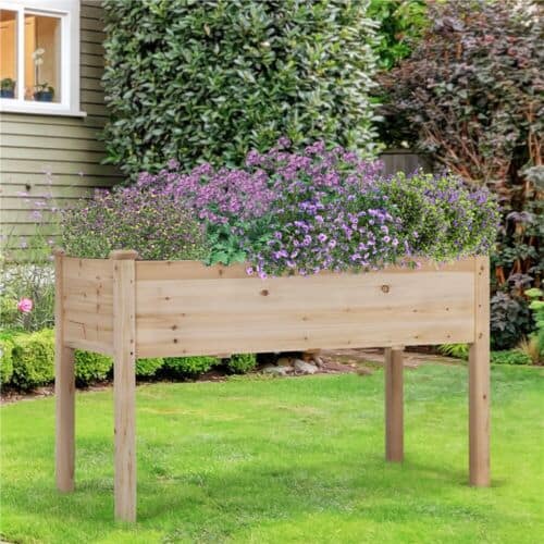 A wooden planter box with purple flowers.
