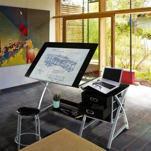 A drawing board with a laptop on it.