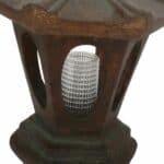 A wooden lamp with a glass shade on top.