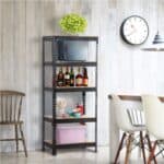 A shelf with bottles and a microwave on top.