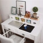 A desk with a computer and a picture frame.