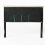 A black headboard with green straps on it.