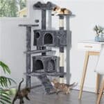 A cat scratching tower with two cats on it.