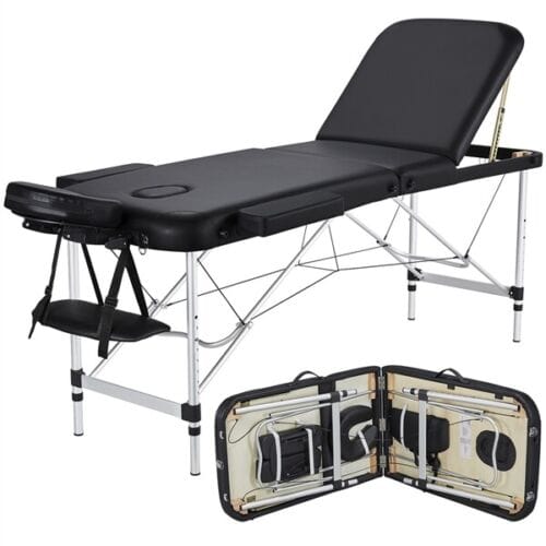 A portable massage table with a black cover.