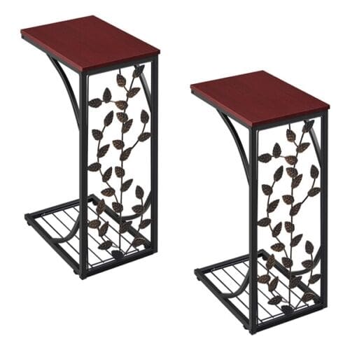 Two metal end tables with leaves on them.
