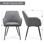 A pair of grey velvet chairs with black legs.