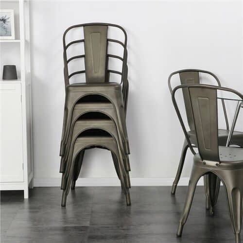 A stack of metal chairs in a room.
