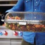 A man is holding a basket full of food.