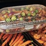 A basket full of vegetables on a grill.