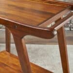 A wooden serving cart with a wooden shelf.