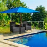 A wicker patio set with a blue umbrella.