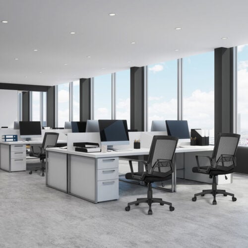 A modern office with desks and chairs.