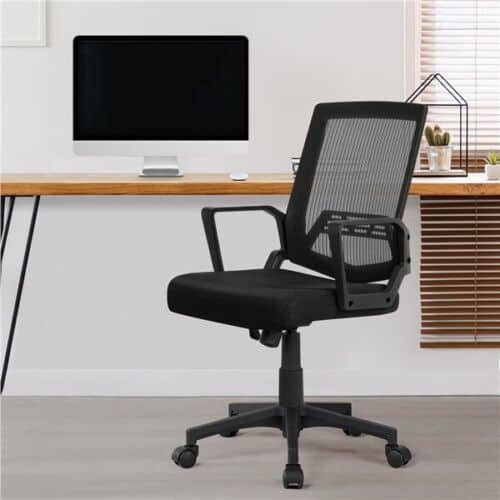 A black mesh office chair in front of a desk.