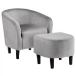 A grey velvet chair and ottoman set.