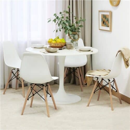 A white dining room with a white table and chairs.