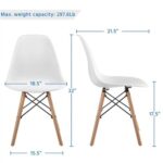 Two white eames chairs with wooden legs.