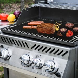 A bbq grill with meat and vegetables on it.