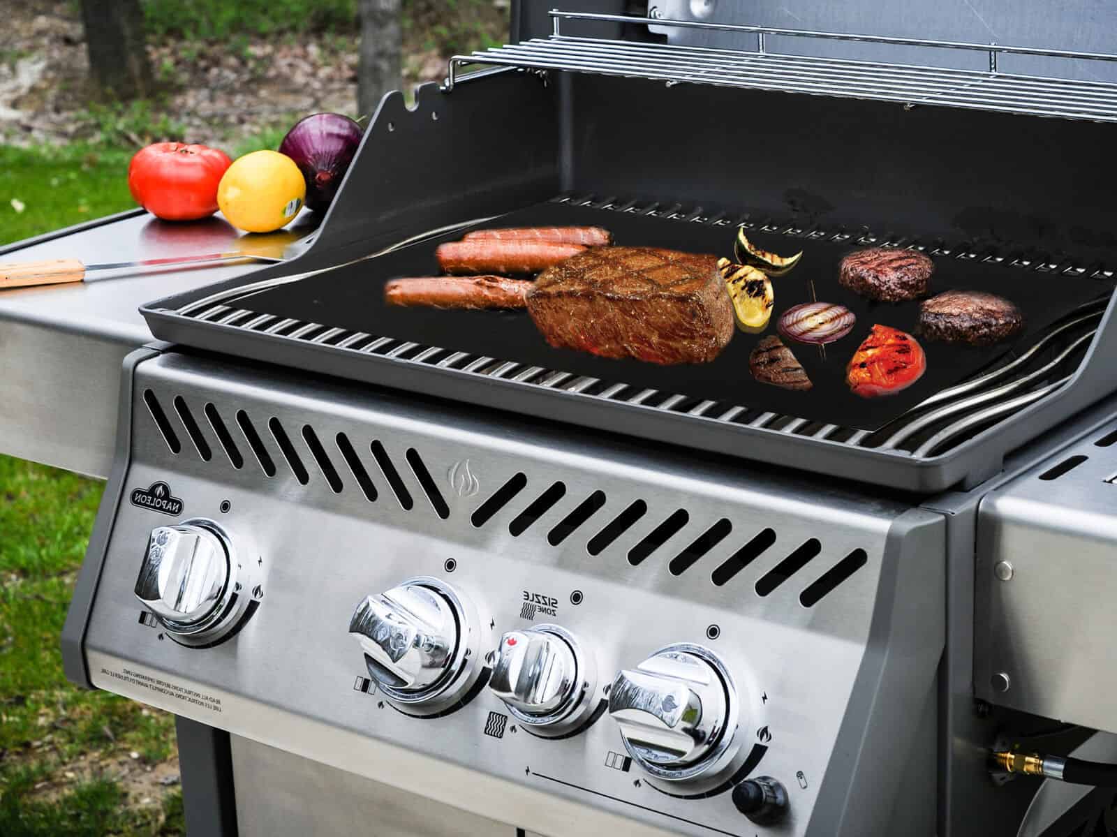 A bbq grill with meat and vegetables on it.