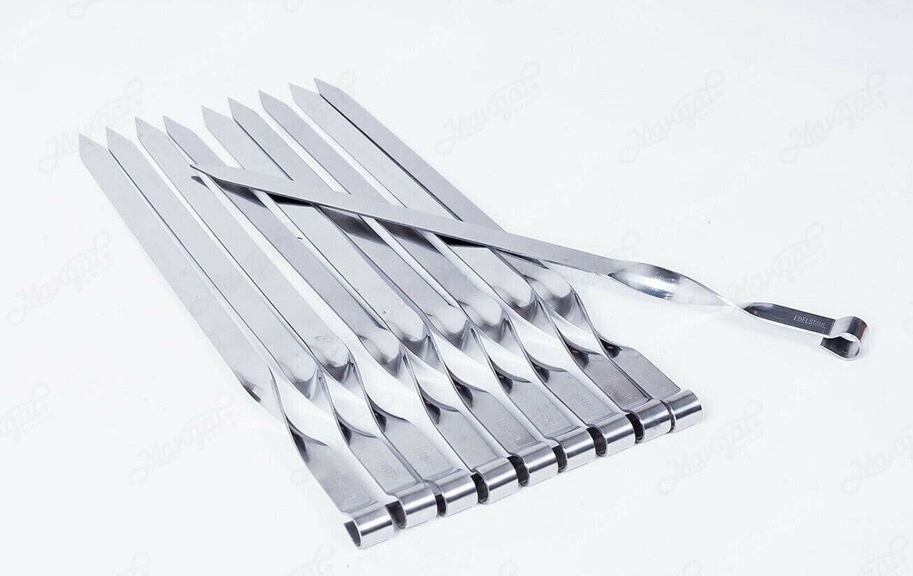A set of stainless steel forks on a white surface.