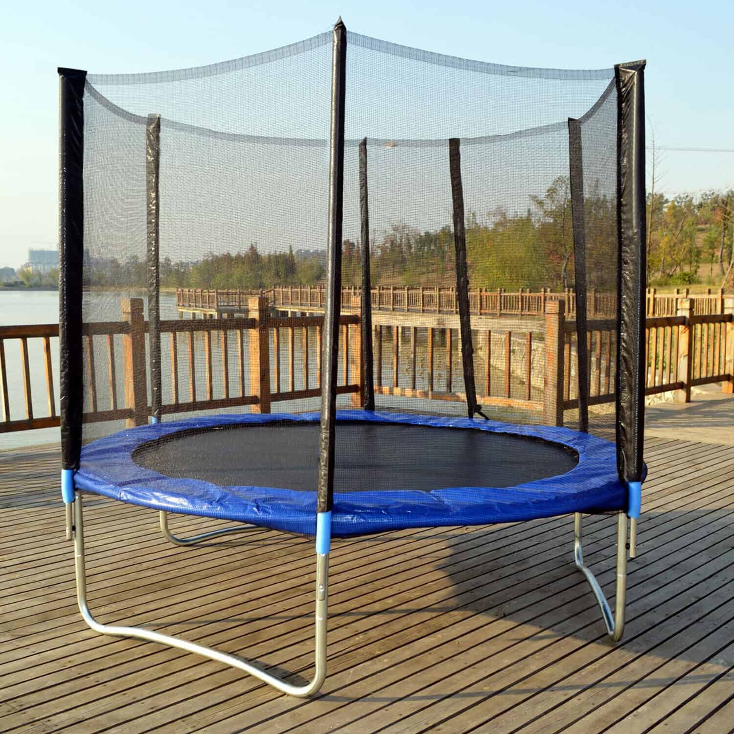 A trampoline with a net on a wooden deck.