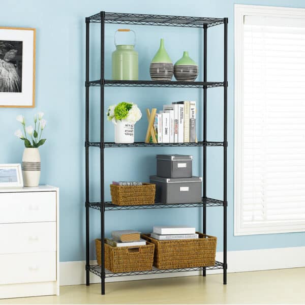 A black, multi-shelf storage unit organized with decorative items, books, and storage baskets against a light blue wall.