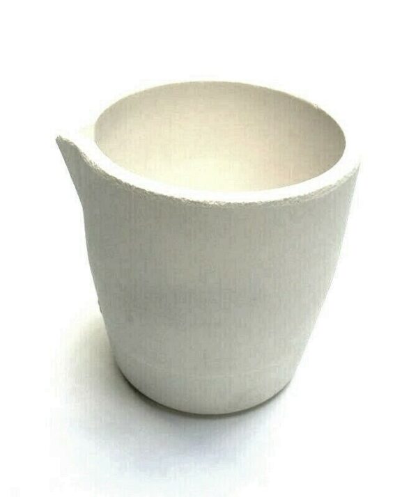 White ceramic cup with broken edge on a white background.