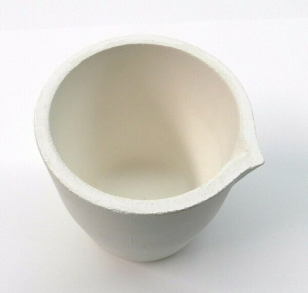 A white ceramic mug with a broken handle.