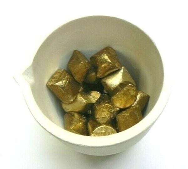 Gold nuggets in a white bowl.