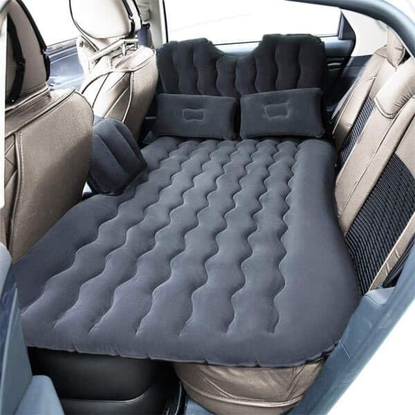 Inflatable car air mattress set up on the back seat of a vehicle.