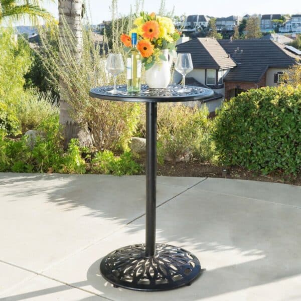 An outdoor table with flowers on it.