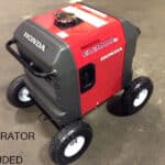 A portable honda generator on a four-wheeled cart with a sign stating "generator not included.