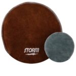 Two circular fabric grips for bowling: one large and brown with "storm" branding, the other smaller and gray.