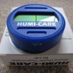 Blue humi-care digital hygrometer displayed on its packaging.