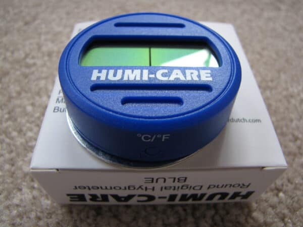 Blue humi-care digital hygrometer displayed on its packaging.