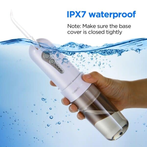 Hand holding a waterproof device with ipx7 rating submerged in water to demonstrate its water resistance.