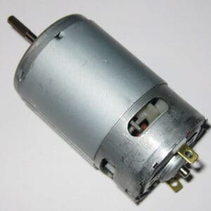 Small dc electric motor with visible gear and electrical connections.
