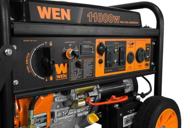 A black and orange portable wen 11000w dual fuel generator with wheels.