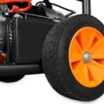 Close-up of an orange wheel on a lawn mower.