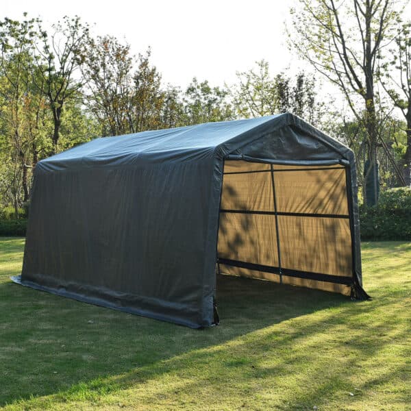 A portable garage canopy set up on grass.