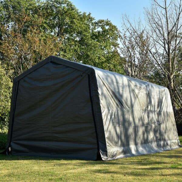 A large, portable garage or storage shelter set up on a grassy area with trees in the background.