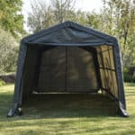 A portable black canopy tent set up on grass.