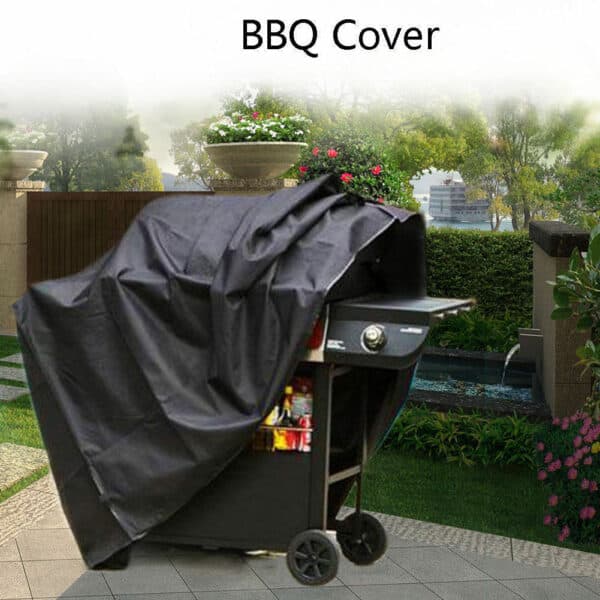 A grill covered with a black bbq cover in a garden setting.