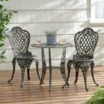 An outdoor table and chairs on a wooden deck.