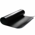 A roll of black material, possibly vinyl or leather, unrolling on a white background.