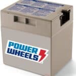 A power wheels branded rechargeable battery in a cardboard box, featuring a large logo and product information on the lid.