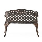 Wrought iron garden bench with lattice design.