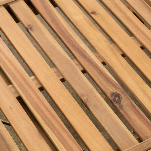 A close up of a wooden slatted bench.
